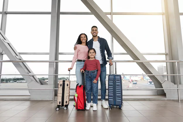 A happy Arab family posing at DXB airport before boarding