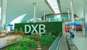 Dubai International Airport DXB, large Emirates Terminal with bright overhead lighting and marble.