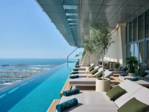 Luxury infinity pool and sun loungers at AURA Skypool Dubai with panoramic skyline views