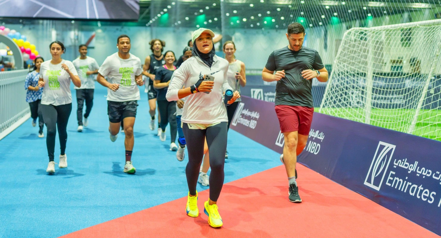 Indoor runners participate in the Dubai Sports World half-marathon inside a climate-controlled arena.