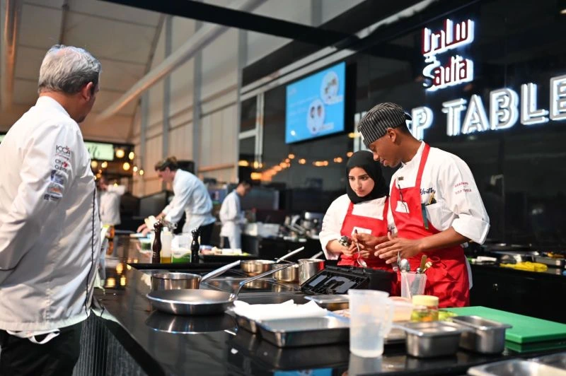 Chef indicating a cooking technique at ICCA