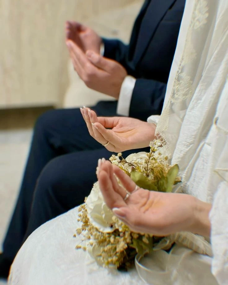 Muslim mates in marriage attire making dua