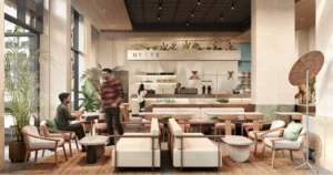 Interior of NETTE Café in Al Barari, Dubai, featuring modern minimalist design with cozy setting and indoor greenery.