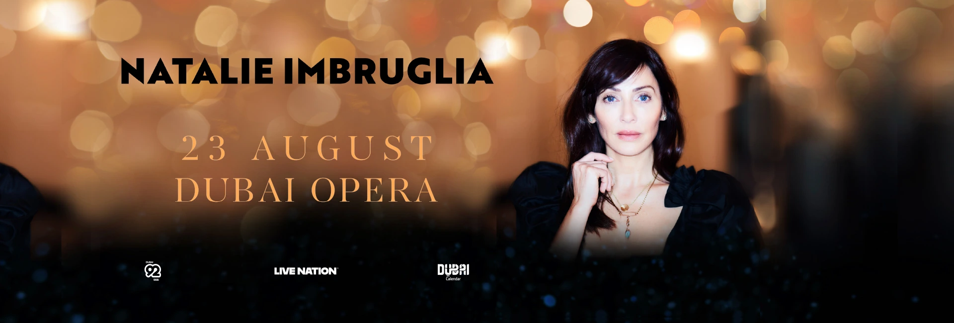 Promotional poster of Natalie Imbruglia for her live show at Dubai Opera on 23 August 2025, with the artist's title in bold black font on the left and her picture on the right.