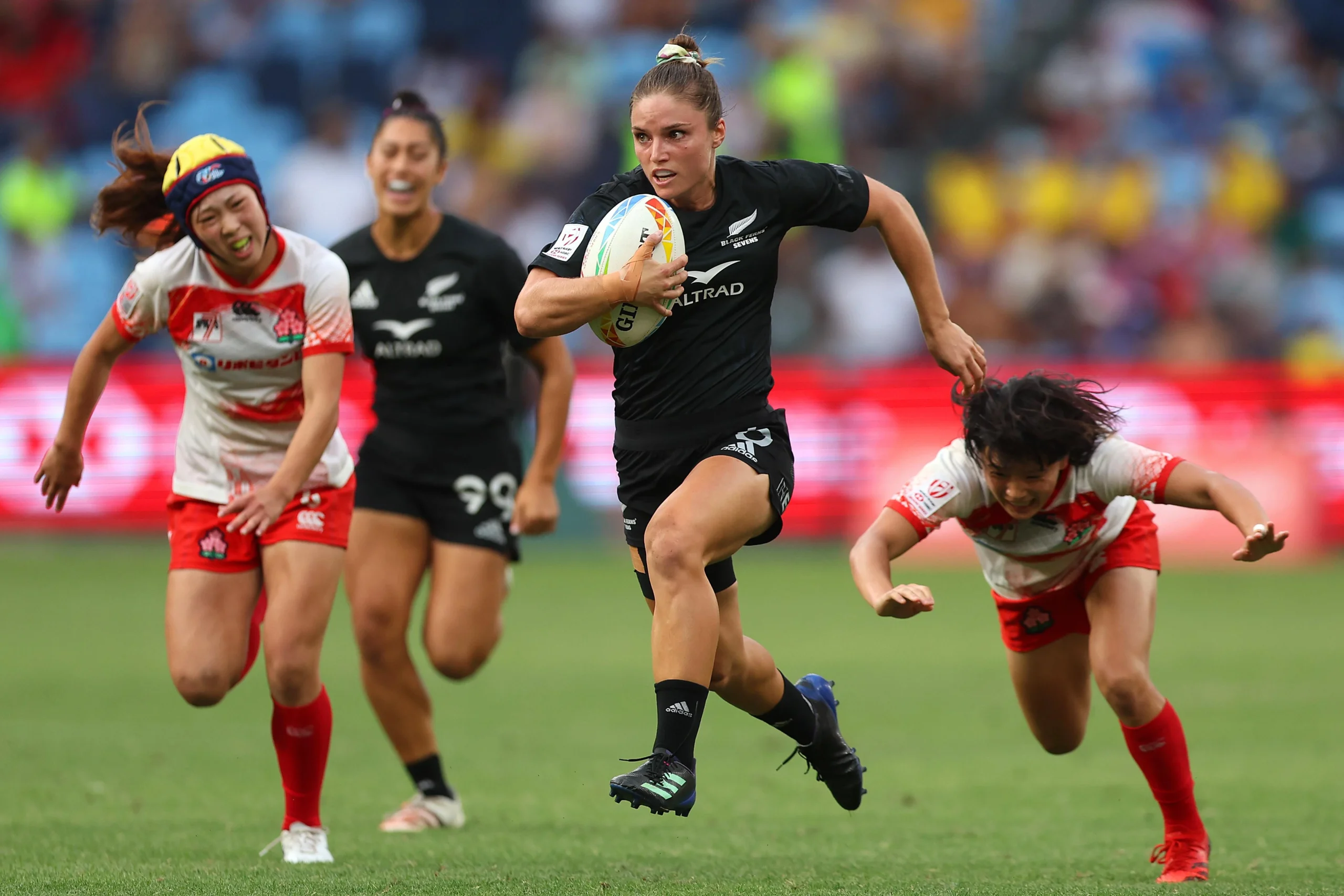 New Zealand rugby 7s players competing against Japan rugby 7s players during the Dubai 7s tournament.