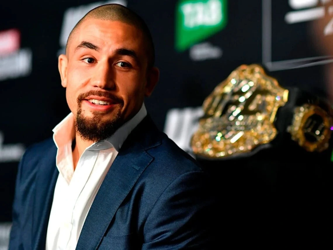 Robert Whittaker posing with the UFC belt.