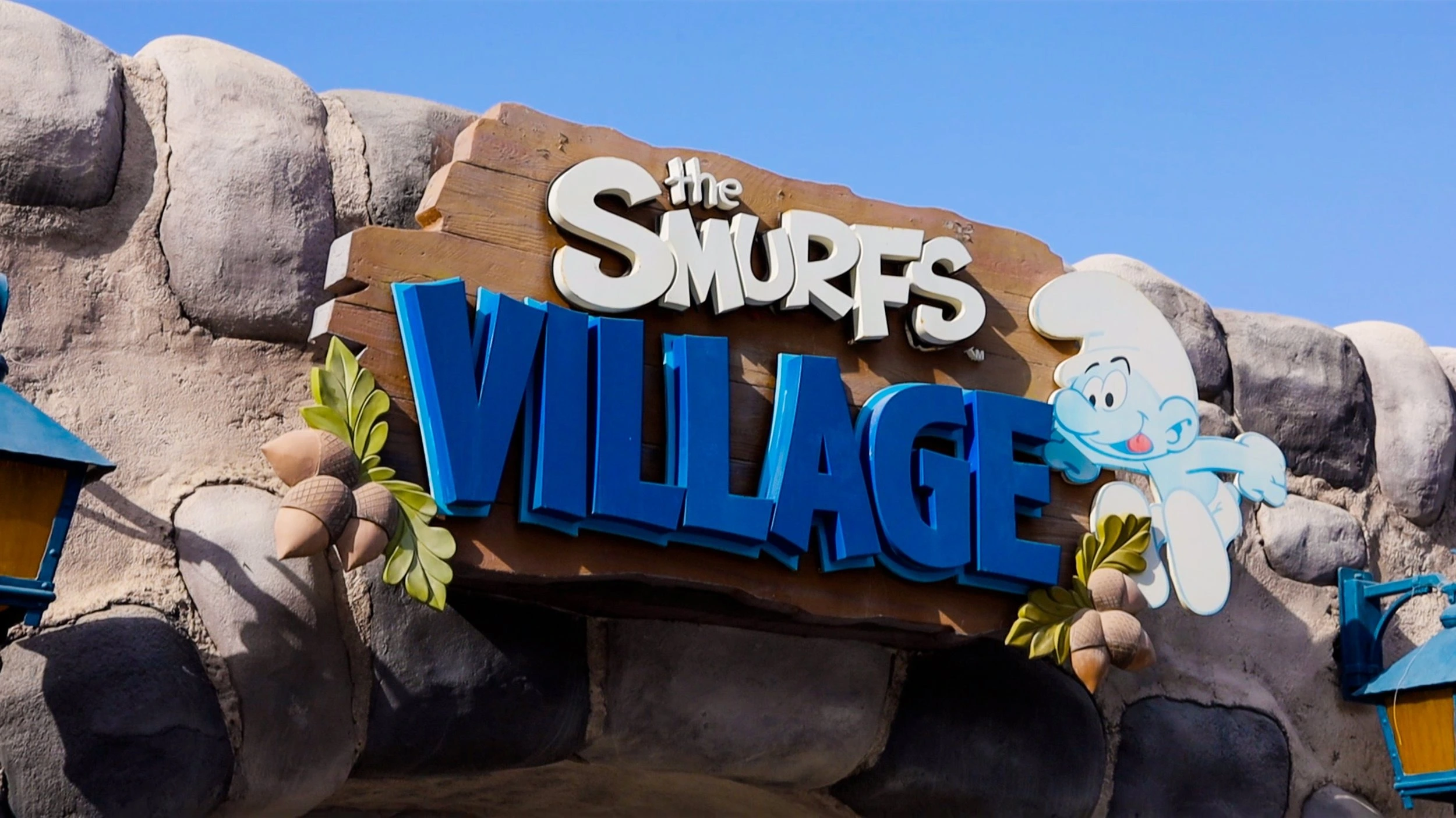 Smurf Village Zone with rocky backdrop and mushroom houses at Motion gate