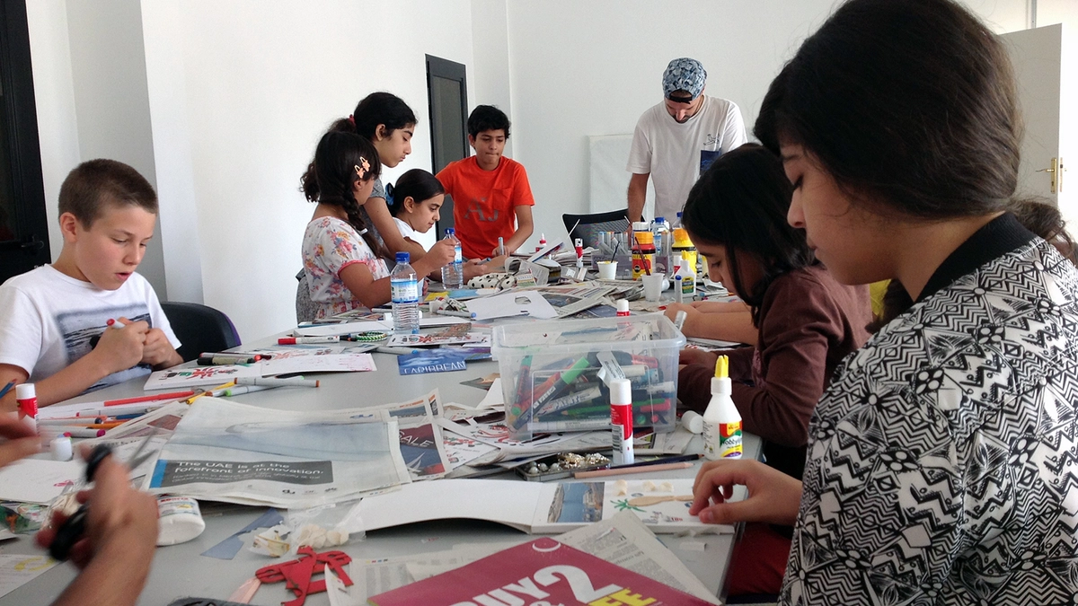 Teens experiencing an arts and crafts workshop with diverse tools start on the table